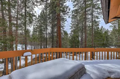 a porch covered in snow with a wooden fence at Tahoe Forest Chalet 3BR House with AC in Stateline