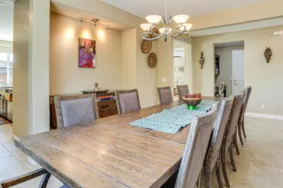 a dining room with a wooden table and chairs at 4 Mi to The Streets of Brentwood Home with Fire Pit in Brentwood