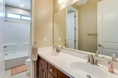a bathroom with a sink and a mirror at 4 Mi to The Streets of Brentwood Home with Fire Pit in Brentwood