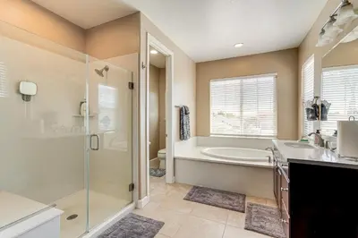 a bathroom with a tub and a shower and a sink at 4 Mi to The Streets of Brentwood Home with Fire Pit in Brentwood