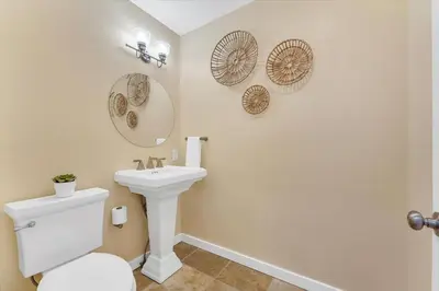 a bathroom with a toilet and a sink at Family Retreat Mountain View with Hot Tub and Mini Golf in Steamboat