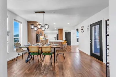 a kitchen and dining room with a table and chairs at Family Retreat Mountain View with Hot Tub and Mini Golf in Steamboat