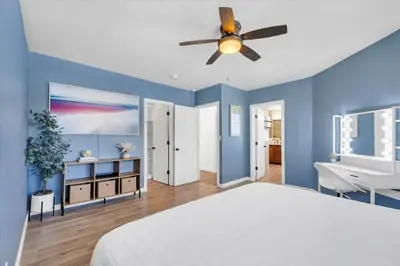 a bedroom with blue walls and a ceiling fan at Family Retreat Mountain View with Hot Tub and Mini Golf in Steamboat