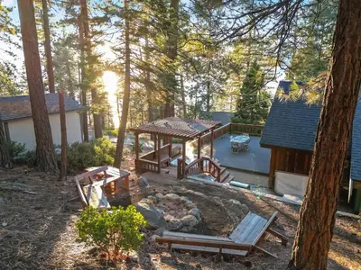 a backyard with a picnic table and a fire pit at Mountainside Overlook Lake Views & Hot Tub in Kings Beach
