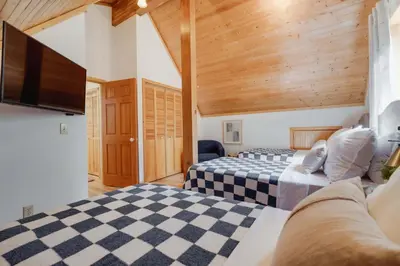 a bedroom with two beds and a flat screen tv at North Lake Hideaway Prime Locale for Outdoor Fun in Alpine Meadows