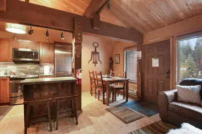 a kitchen and dining room with a table and a couch at North Lake Tahoe Alpine Retreat 5 Min to Skiing in Alpine Meadows
