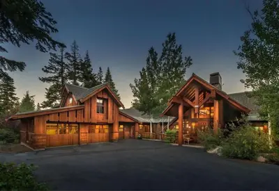 a large wooden house with a driveway at Luxury Northstar Palace with Hot Tub & Games in Truckee