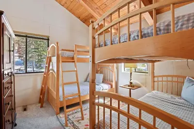 a bunk bed room with two bunk beds and a ladder at Northstar Treehouse Chic 4BR House Forest view in Truckee