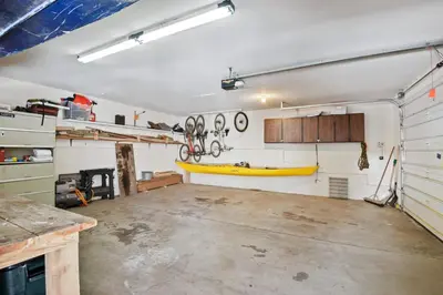 a garage with a boat hanging on the wall at Northstar Treehouse Chic 4BR House Forest view in Truckee