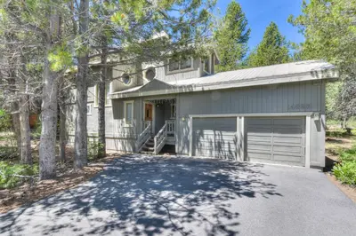 a house with a driveway and a garage at Northwoods Hangout Near Tahoe Donner in Truckee