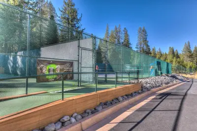 a tennis court inside of a fence with a tennis court at Northwoods Hangout Near Tahoe Donner in Truckee