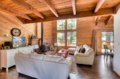 a living room with white furniture and wood ceilings at Northwoods Hangout Near Tahoe Donner in Truckee