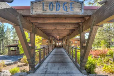 a wooden bridge with a sign that reads lodge at Paradise Pines 3BR Secluded Cabin Minutes in Tahoe Donner in Truckee