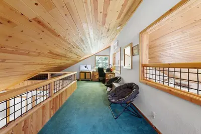 a room with a wooden ceiling and a chair at Paradise Pines 3BR Secluded Cabin Minutes in Tahoe Donner in Truckee