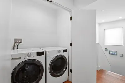 a washer and dryer in a white laundry room at Enjoy Paradise Hot Tub Bike & Beach Equipment in Olympic Valley