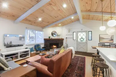 a living room with a couch and a fireplace at Pino Point Steps to Tahoe Beaches in Tahoe Vista