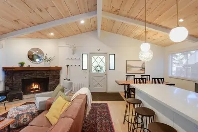 a living room with a couch and a fireplace at Pino Point Steps to Tahoe Beaches in Tahoe Vista