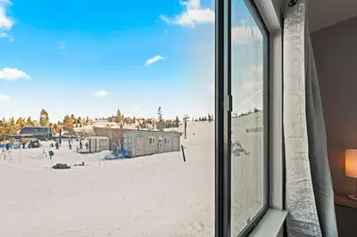 a view from a window of a ski resort at Powder Run Retreat Modern Stay for 6 With On-site Ski Access & Mountain Views in Truckee