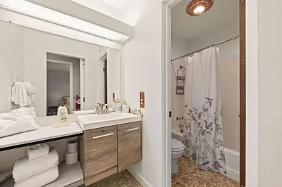 a white bathroom with a sink and a toilet at Powder Run Retreat Modern Stay for 6 With On-site Ski Access & Mountain Views in Truckee