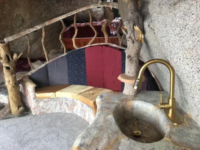a small bed in a room with a tree at Lord of the rings palice in Wofford Heights