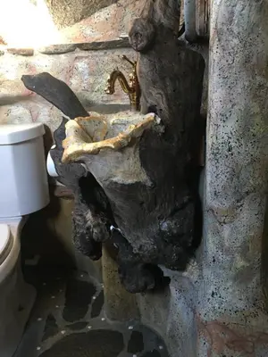a dirty bathroom with a sink and a toilet at Lord of the rings palice in Wofford Heights
