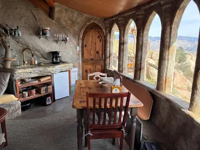 a kitchen with a wooden table and some windows at Lord of the rings palice in Wofford Heights