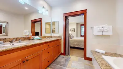 a bathroom with two sinks and a large mirror at Timbers #2 townhouse in Mammoth Lakes