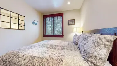 a bedroom with a bed and a window at Timbers #2 townhouse in Mammoth Lakes