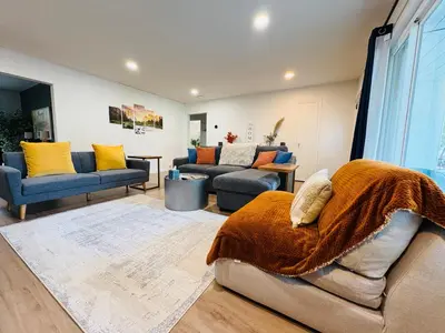 a living room with two couches and a rug at Downtown-Pool,Firepit,Trees, WFH-No gate fee like PML in Groveland