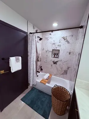 a bathroom with a bath tub and a basket at Downtown-Pool,Firepit,Trees, WFH-No gate fee like PML in Groveland