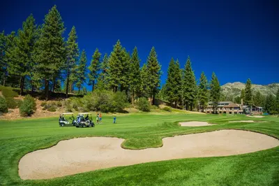 a golf course with a golf cart on a green at The Tahoe Nest in Incline Village