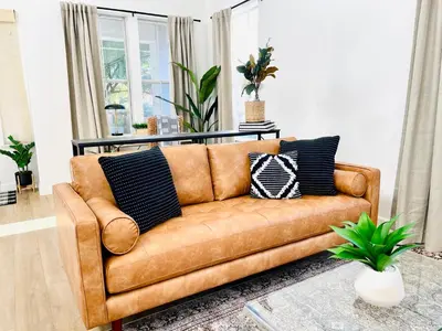 a brown leather couch in a living room at Huge Home near Old Folsom Pet & Family Friendly in Folsom