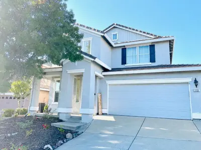 a white house with a garage at Huge Home near Old Folsom Pet & Family Friendly in Folsom