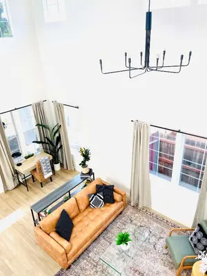 a living room with a brown couch in a room with windows at Huge Home near Old Folsom Pet & Family Friendly in Folsom