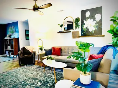 a living room with a couch and some plants at Remodeled Excellent Neighborhood in Roseville