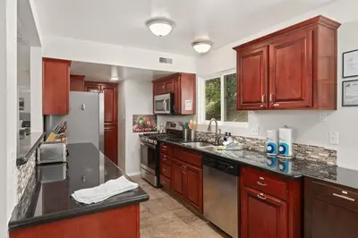 a kitchen with wooden cabinets and a stainless steel appliances at Rivertop Hideaway in Ahwahnee