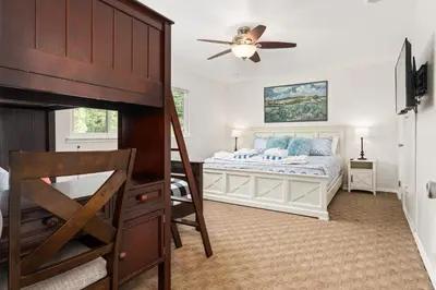 a bedroom with a bed and a ceiling fan at Rivertop Hideaway in Ahwahnee