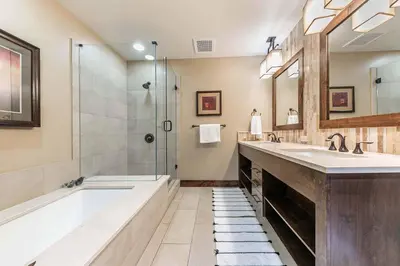 a bathroom with a tub and a sink and a shower at Northstar Lodge 306 by East West Hospitality in Truckee