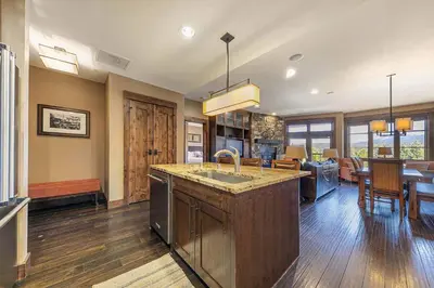 a kitchen with a sink and a living room at Northstar Lodge 306 by East West Hospitality in Truckee