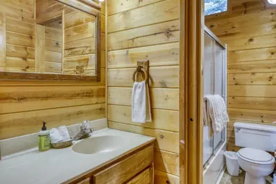 a bathroom with a sink and a toilet at Resting Bear Lodge by Tahoe Getaways - Pet Friendly w Foosball and HOA Amenities in Truckee
