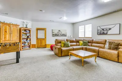 a living room with a couch and a table at Resting Bear Lodge by Tahoe Getaways - Pet Friendly w Foosball and HOA Amenities in Truckee