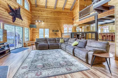 a living room with a couch and a rug at Resting Bear Lodge by Tahoe Getaways - Pet Friendly w Foosball and HOA Amenities in Truckee
