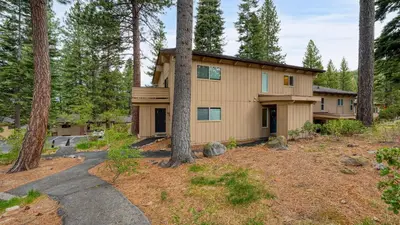 a house in the woods with a path leading to it at Ski Way by AvantStay Cozy Tahoe Home w Fireplace Balcony in Incline Village