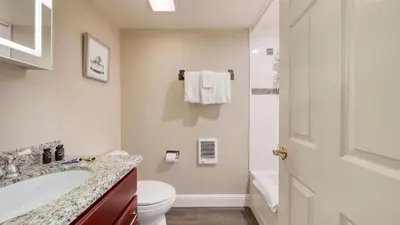 a white bathroom with a sink and a toilet at Ski Way by AvantStay Cozy Tahoe Home w Fireplace Balcony in Incline Village