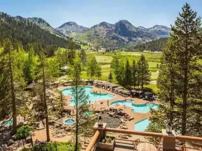 a view of a river with trees and mountains at Everline Resort & Spa Palisades- Forest View in Olympic Valley