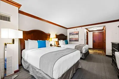 a hotel room with two beds and a television at Everline Resort & Spa Palisades- Forest View in Olympic Valley