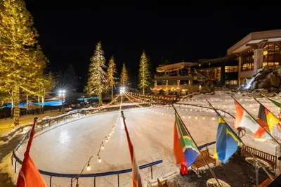 an ice rink at night with flags and lights at Everline Resort & Spa Palisades- Valley View in Olympic Valley