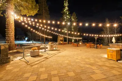 a string of lights over a patio at night at Everline Resort & Spa Palisades- Valley View in Olympic Valley