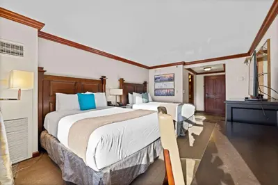a hotel room with two beds and a television at Everline Resort & Spa Palisades- Valley View in Olympic Valley