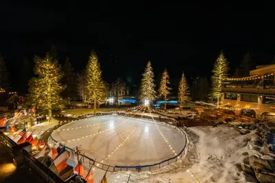 an ice skating rink at night with christmas trees at Everline Resort & Spa Palisades- Valley View in Olympic Valley